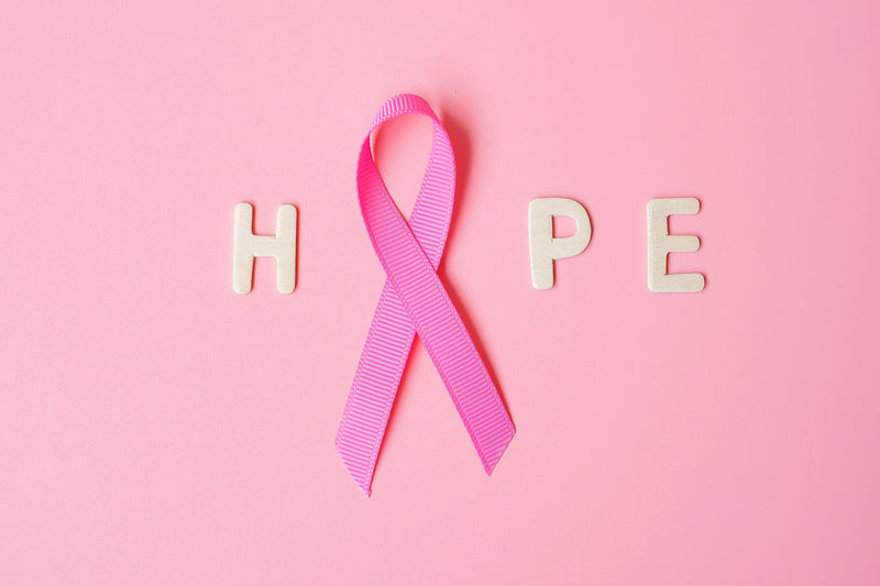 The word hope with a pink ribbon forming the letter O representing hope and health coverage during cancer diagnosis
